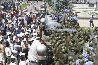 Las fuerzas de seguridad de Kirguizistán bloquean a centenares de manifestantes el acceso a la sede del Gobierno ayer en Bishkek.