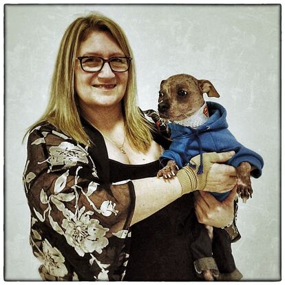 BIRMINGHAM, ENGLAND - MARCH 07: (EDITORS NOTE: This image was created using digital filters) Bev Nicholson from Peterborough poses for a photograph with her Chinese Crested dog named Mugly on the third day of Crufts dog show at the National Exhibition Centre on March 7, 2015 in Birmingham, England. First held in 1891, Crufts is said to be the largest show of its kind in the world, the annual four-day event, features thousands of dogs, with competitors travelling from countries across the globe to take part and vie for the coveted title of 'Best in Show'. (Photo by Carl Court/Getty Images)