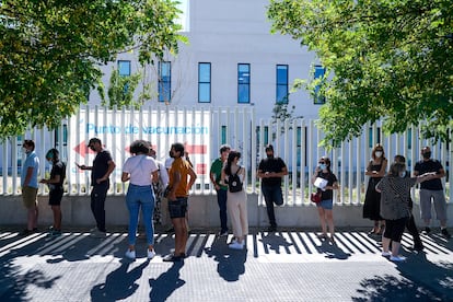 People wait in line to be vaccinated outside Isabel Zendal Hospital in Madrid.
