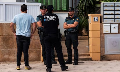 Fuerzas de seguridad en el portal de la vivienda donde una mujer ha sido asesinada, este domingo, en Mallorca.