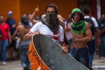 Manifestantes carregam um orelhão para fazer uma barricada durante o protesto contra a reintegração de posse que desalojou 205 famílias na manhã desta terça.