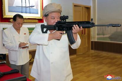 North Korean leader Kim Jong Un, right, holds a weapon during his three-day inspection from Aug. 3 until Aug. 5, 2023