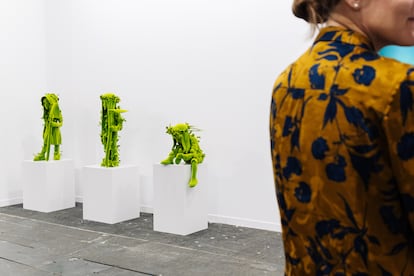 Una mujer junto a las obras 'Farmer Girl', 'Farmer Boy', y 'Planter', de Kim Simonsson, este miércoles durante la inauguración de Arco Madrid 2024.