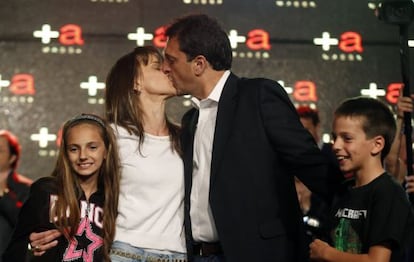 Sergio Massa, mayor of Tigre near Buenos Aires, kisses his wife Malena next to their children after the results of Sunday&#039;s legislative elections were announced.