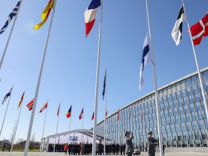 Military personnel raise the Finnish flag during a ceremony on the sidelines of a NATO foreign ministers meeting at NATO headquarters in Brussels, on April 4, 2023.