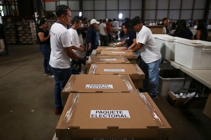 Election workers seal boxes with election forms ahead of the presidential elections in San Marcos, El Salvador, January 23, 2024