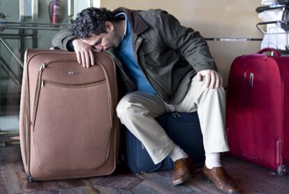 A passenger tries to get some rest in Barcelona's El Prat airport.