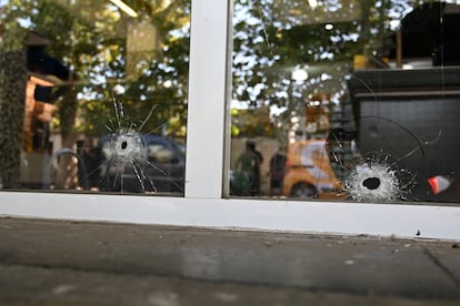 Bullet holes in the door of the supermarket belonging to the family of Antonela Roccuzzo, wife of Argentinean soccer star Lionel Messi.