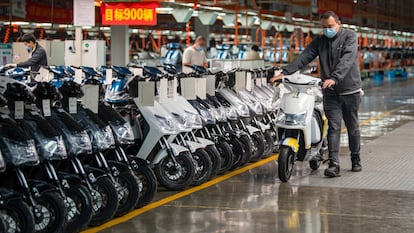 Employees work on the assembly line of electric bicycles at a workshop of Zhejiang Luyuan Electric Vehicle Co., Ltd on October 8, 2022 in Jinhua, Zhejiang Province of China.