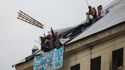 Un grupo de presos amotinados arroja una escalera desde el techo de la cárcel federal de Devoto, en la ciudad de Buenos Aires, el 24 de abril.