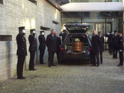 The coffin with the remains of the police officer who died during a shootout with a bank robber on Friday.