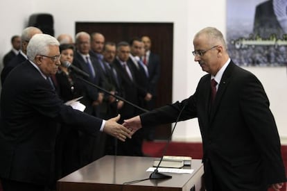 Rami Hamdalá le estrecha la mano a Mahmud Abbas tras jurar el cargo, el jueves.