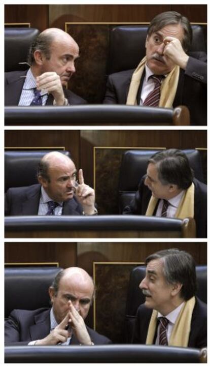 El ministro de Economía y Competitividad, Luis de Guindos, conversa con el exministro socialista Valeriano Gómez.