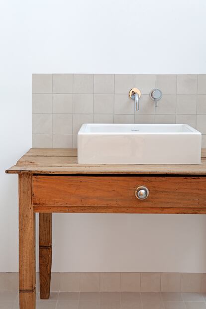 Un taburete de madera o una mesita vintage será un mueble de baño si modificamos los cajones para contener la pila y las tuberías.