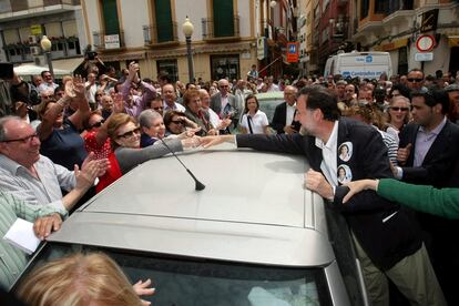 Mariano Rajoy saluda a una mujer entre el gentío en una visita a Elche.