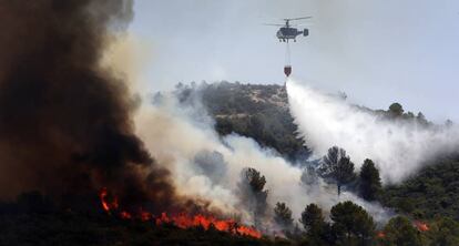 Un helicóptero descarga agua en el incendio forestal de Llutxent este verano. 