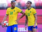 Brazil's forward Richarlison and Brazil's forward Antony (R) stand together during the Tokyo 2020 Olympic Games men's semi-final football match between Mexico and Brazil at Ibaraki Kashima Stadium in Kashima city, Ibaraki prefecture on August 3, 2021. (Photo by PEDRO PARDO / AFP)