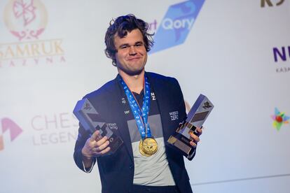 Magnus Carlsen with his rapid and blitz chess world titles in Almaty.
