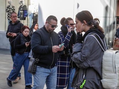 Usuarios de telefonía móvil en la Gran Vía de Madrid.