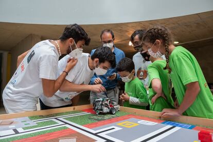 Tres miembros del jurado verifican si el robot de los concursantes ha funcionado correctamente durante el torneo de robótica, en Cáceres.