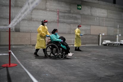 A patient is taken to the Ifema convention center, which has been converted into a temporary field hospital.