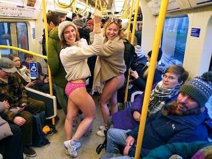 People on board a tube as they take part in the annual event "No Trousers Tube Ride" in London, Sunday, Jan. 12, 2025. (AP Photo/Alberto Pezzali)