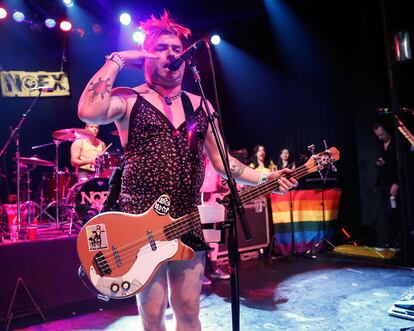 Fat Mike de NOFX actúa junto a una bandera LGTB. Fueron de los primeros grupos en ponerla en el escenario durante algunas actuaciones.