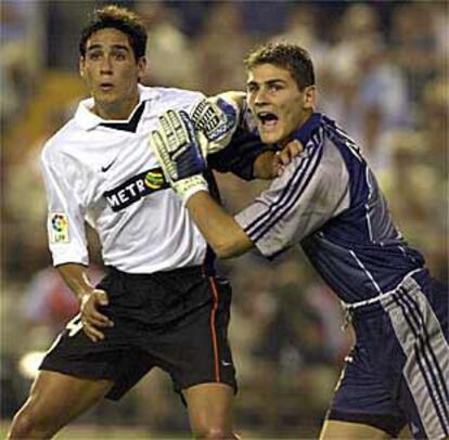 Vicente y Casillas forcejean mientras esperan el balón.