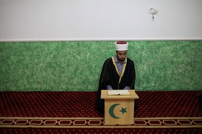Un Imam lee el Corán dentro de una mezquita durante los rezos del viernes en Sremcica, Belgrado.