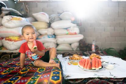 En un análisis realizado en 91 países, el informe concluye que solo la mitad de los y las bebés de entre seis y 23 meses se alimentan diariamente con el número de comidas recomendado, mientras que solo una tercera parte consume el mínimo de grupos de alimentos que necesitan para desarrollarse. Ariet, de dos años, come sandía, una de sus frutas favoritas, en su casa en la aldea de Kurshab, Osh Oblast, Kirguistán, el 1 de septiembre de 2021. Además de la sandía, a Ariet también le gustan los melocotones y los pepinos, y le encanta la 'manty' (albóndigas) y sopa shorpo (carne hervida con verduras).