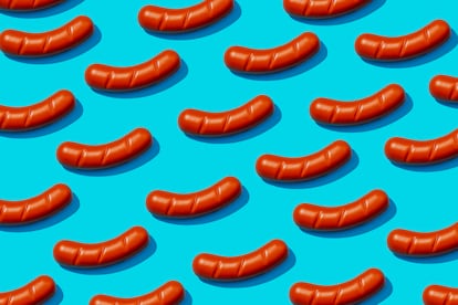 pattern of fake cooked sausages on a blue background