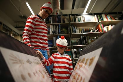 A man and a boy, dressed as the character Waldo, at an event in a London bookstore in September 2019.