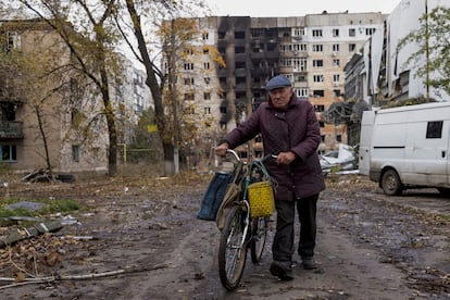 A resident of Avdiivka, in Ukraine’s Donetsk region, walks between bombed buildings on October 17, 2023. 