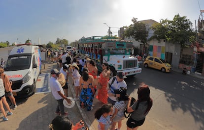 Tourists wait to board a bus in Cartagena, Colombia.