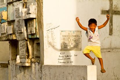 Un niño salta un nicho portando las fichas del juego de tazos.