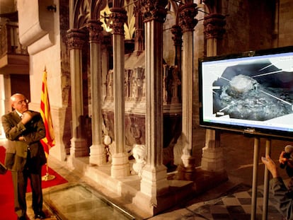 El consejero Tresserras en Santes Creus, junto a la tumba del rey Pere el Gran y la imagen que muestra su momia.