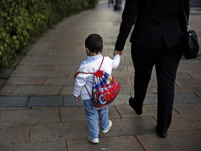 Una madre acompa&ntilde;a a un ni&ntilde;o al colegio