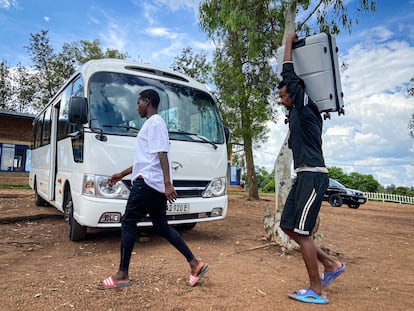 Refugees traveling to Canada load their bags onto a bus that will take them to the airport.