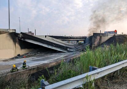 Philadelphia Fire Department shows firefighters standing near the collapsed part of I-95 in Philadelphia