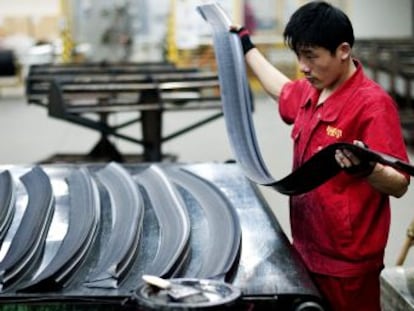 Un trabajador manipula caucho en una f&aacute;brica de Pirelli en China.