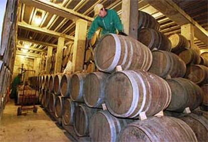 Un operario manipula barriles en una bodega en Navarra.