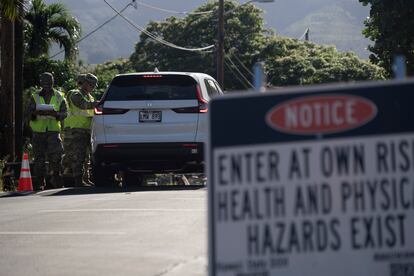 The Hawaii National Guard checks on a car passing the checkpoint on Kaniau Street on Monday, Sept. 25, 2023