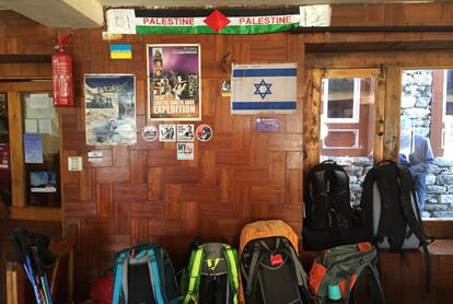 This April 7, 2016 photo shows a Palestinian banner and an Israeli flag displayed on the wall of a dining hall in a lodge in Tengboche, Nepal. Many trekkers hang flags in tea houses to mark their journey and express national pride. A trek to Everest Base Camp along mountain paths that hug deep gorges offers renewal and a test of mental and physical limits. Along the way there are sore knees and altitude sickness, but the spectacular landscapes, friendly villagers and moments of tranquility make the journey an unforgettable experience. (AP Photo/Karin Laub)