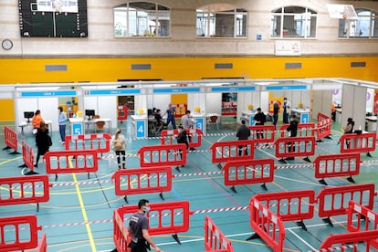 People wait in line to receive the Covid-19 vaccine at a sports center in Palma de Mallorca in Spain‘s Balearic Islands.