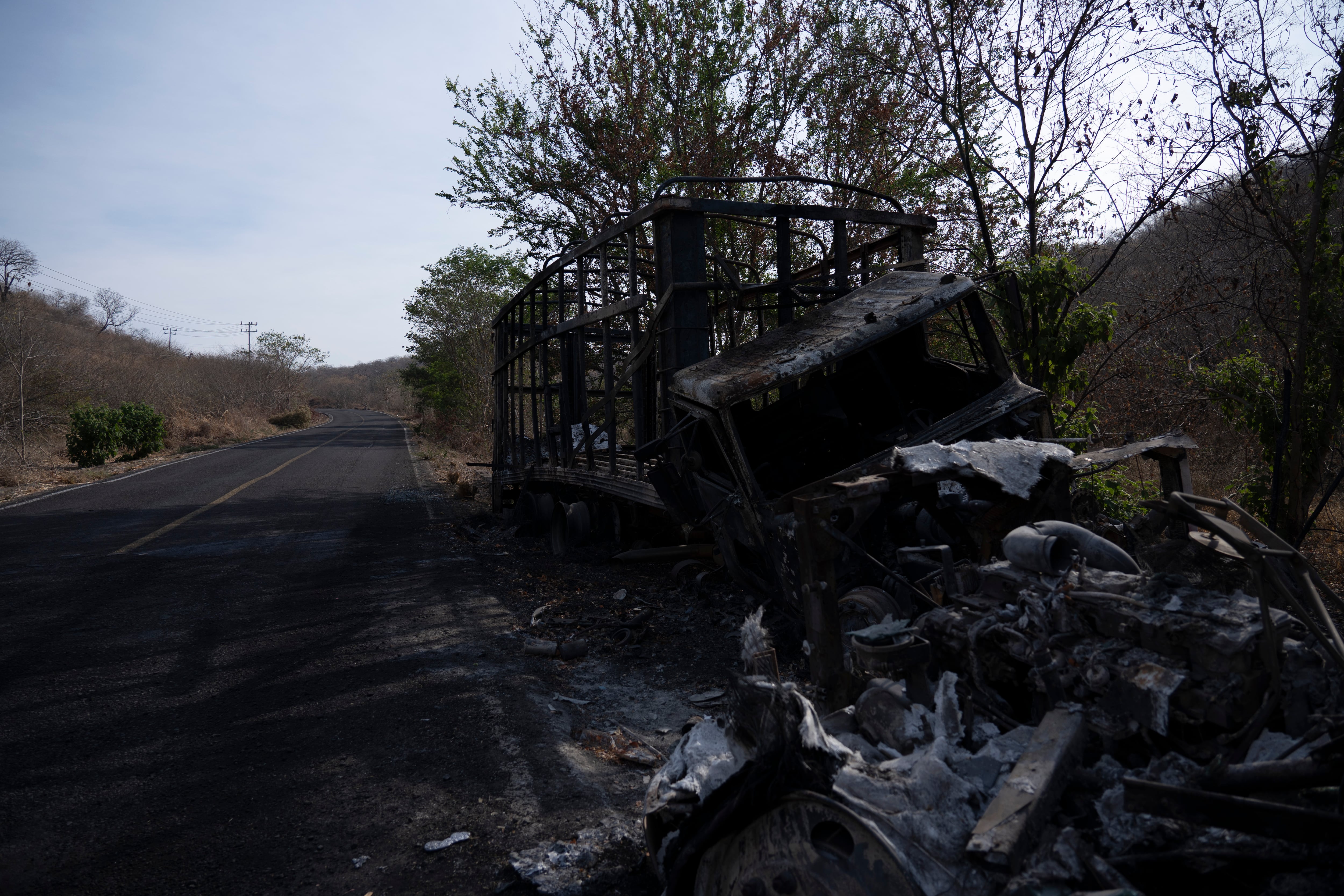 Vehículos calcinados en la arretera que une Apatzingan y Aguililla, en Michoacán, en abril de 2021.