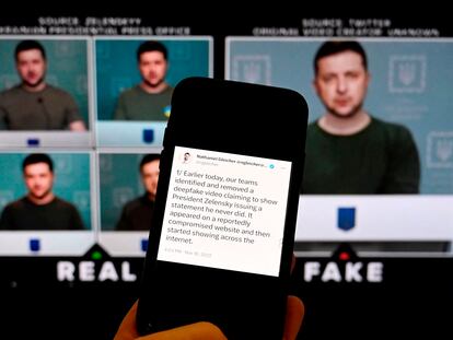 A phone shows a statement from META's head of security policy about a fake video of Ukrainian President Volodymyr Zelensky.