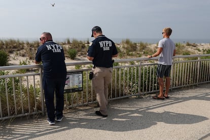 An officer in the NYPD technical assistance response unit (TARU) flies a drone monitoring the ocean at Beach 59th Street, in New York City, where a swimmer was attacked by a shark.