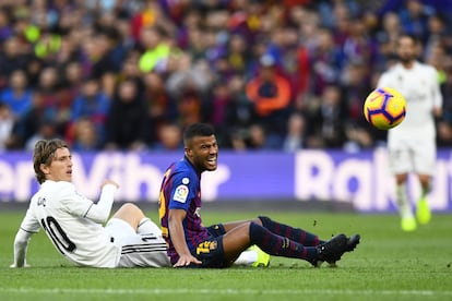 Luka Modric (izquierda) y Rafinha siguen la trayectoria del balón.