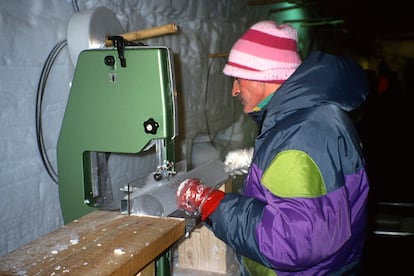 Glaciologist Jean Jouzel cuts ice during an expedition to Greenland in July 1992.
