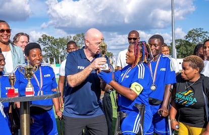 FIFA president Gianni Infantino presents a trophy to the members of the Nyarugenge women's Amputee Football team after their win over Musanze women's amputee football team, after the launch of the women's Amputee Football championship in Rwanda, at the Pele Stadium, in Kigali, Rwanda March 16, 2023.